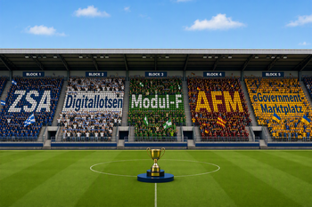 Auf dem Bild ist ein Fußballstadion mit einer Trophäe in der Mitte im WM-Fieber zu erkennen. Auf den Zuschauertribünen sind die Namen "ZSA", "Digitallotsen", "Modul-F", "AFM", und "eGovernment-Marktplatz" zu erkennen. 